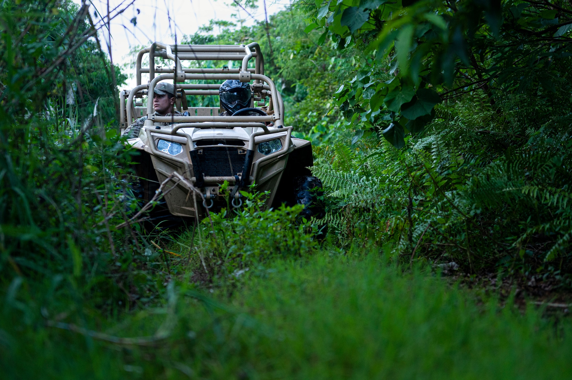 U.S. Air Force Staff Sgt. Alfredo Gutierrez, 36th Security Forces Squadron jungle enforcement squad leader, and Staff Sgt. Nicholas Stillwell, 36th SFS fire team leader, do perform a perimeter check in a Polaris MRZR on Andersen Air Force Base Guam, Sep. 22, 2022. The Jungle Enforcement Team spends about eight hours a day patrolling the jungle looking for tracks, shotgun shells, dead carcasses, trash or people trespassing. (U.S. Air Force photo by Airman Spencer Perkins)