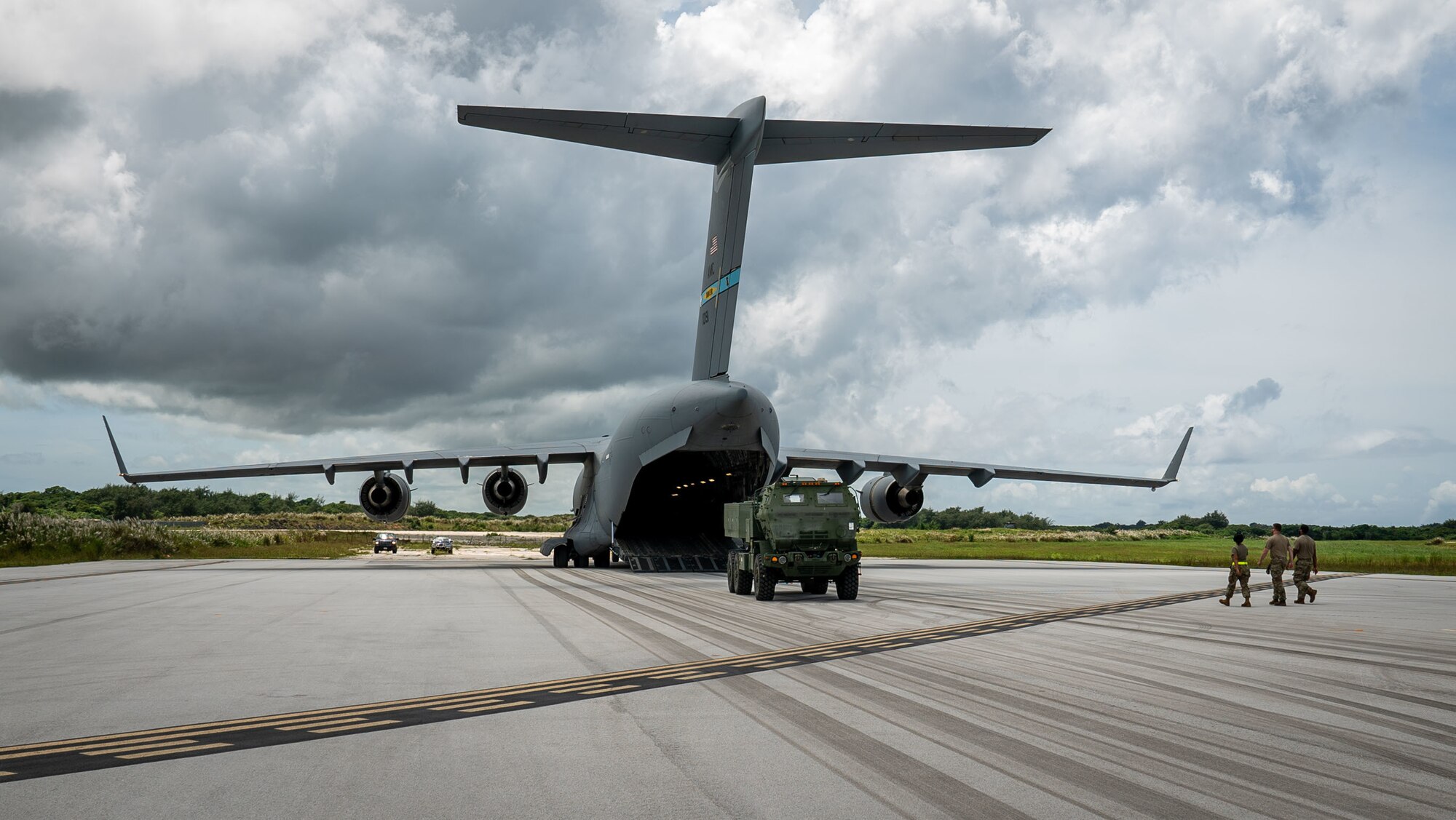 Members of the U.S. Army prepare to load a High Mobility Artillery Rocket System onto a U.S. Air Force C-17 Globemaster III assigned to Dover Air Force Base, Delaware, during Exercise GOLDEN BEE at Andersen Air Force Base, Guam, Sept. 26, 2022.  Exercise GOLDEN BEE is a joint readiness exercise led by Air Mobility Command and was designed to provide training integration and rehearse strategic and operational objectives in support of Agile Combat Employment initiatives in the Indo-Pacific area of responsibility. (U.S. Air Force photo by 1st Lt. Jade Watkins)