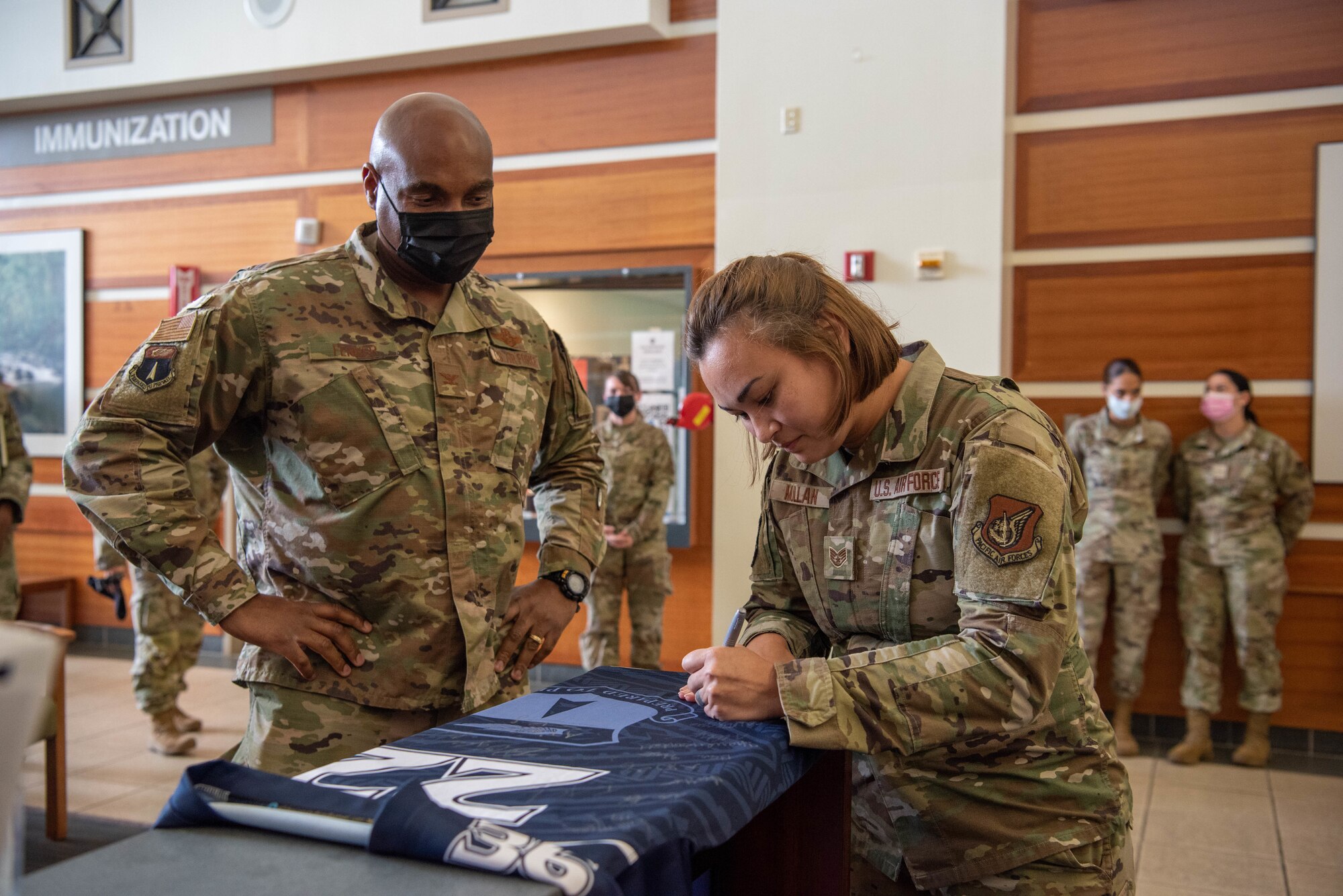 U.S. Air Force Staff Sgt. Jessa Mullan, mental health administrator with the 36th Medical Group, signs the official Linebacker of the Week jersey at Andersen Air Force Base, Guam, Sept. 21, 2022. The Team Andersen Linebacker of the Week recognizes outstanding enlisted, officer, civilian and total force personnel who have had an impact on achieving Team Andersen’s Mission, Vision and Priorities. (U.S. Air Force photo by Airman 1st Class Allison Martin)