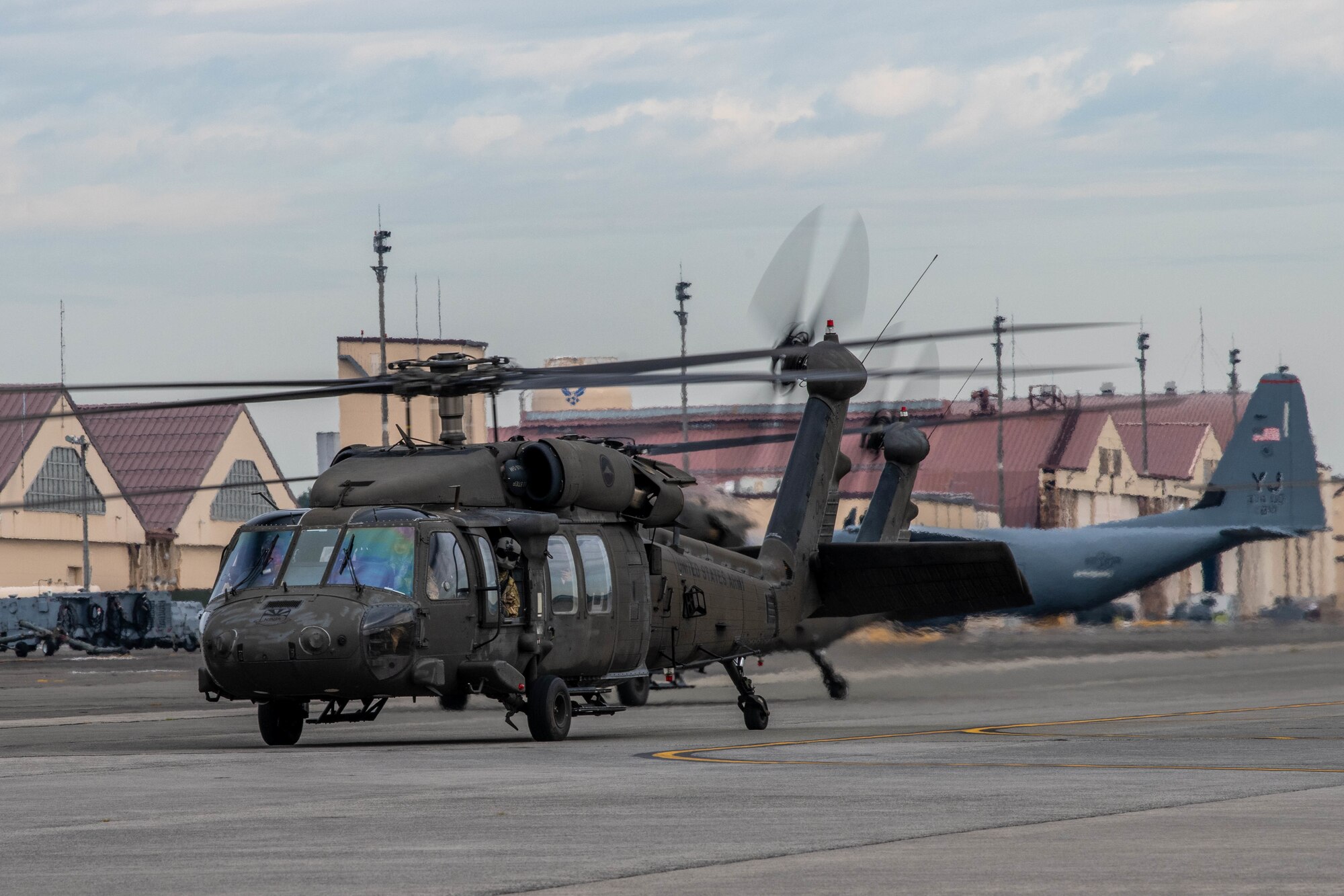 UH-60 Black Hawk helicopters taxi down a flightline