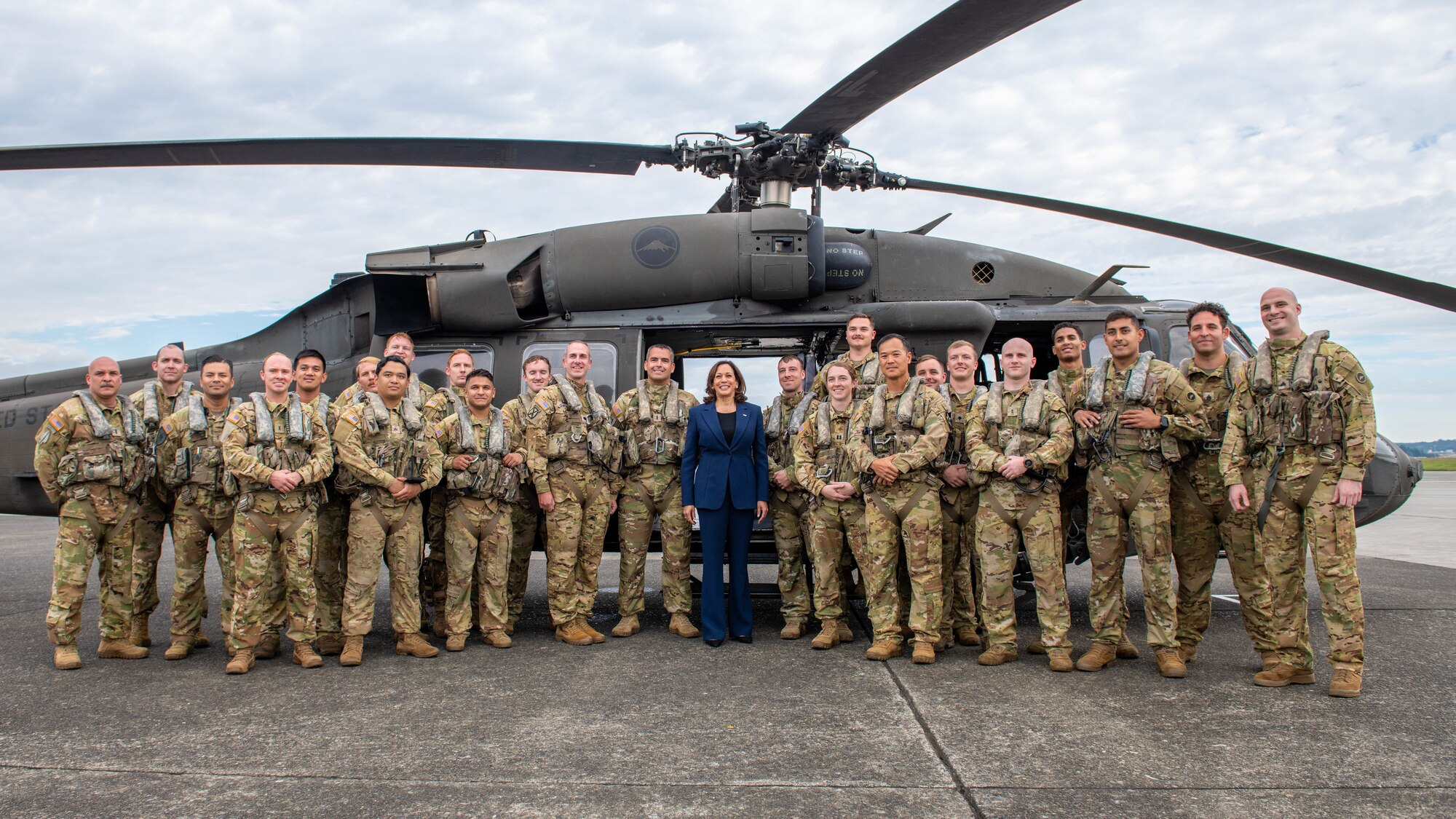 Vice President Harris poses for a group photo with troops