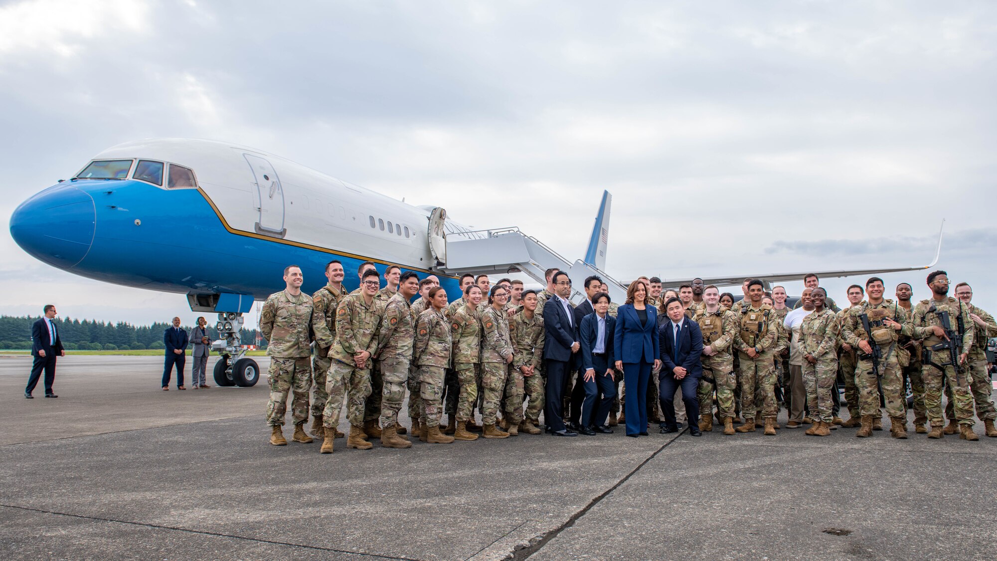 Vice President Harris poses for a group photo with troops