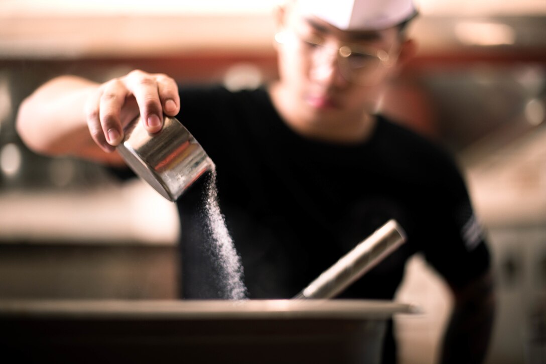 U.S. Marine Corps Lance Cpl. Jhaezel Dy, a food service specialist, Marine Corps Base Hawaii,  prepares food during Chef of the Quarter, MCBH, Sept. 23, 2022. Chef of the Quarter competitions allow an opportunity for food service specialists to hone their craft, while fostering competition and esprit de corps. (U.S. Marine Corps photo by Lance Cpl. Christian Tofteroo)
