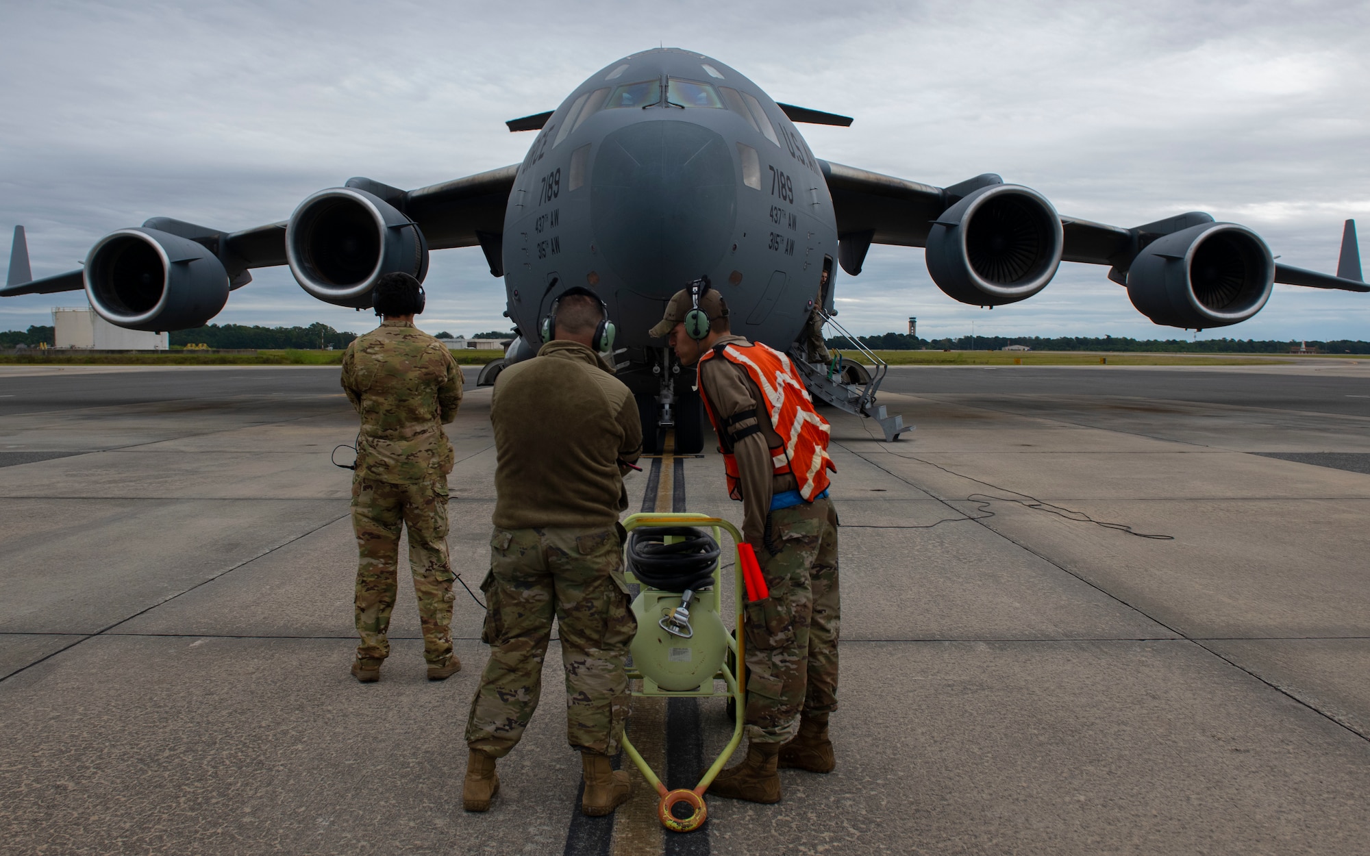 Airmen prepare to marshall an aircraft.