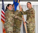 Lt. Col. Carla Martinez, 433rd Maintenance Group commander, presents the 433rd Aircraft Maintenance Squadron guidon to Maj. Nicholas Velazquez Jr. during the 433rd AMXS change of command ceremony at Joint Base San Antonio-Lackland, Texas, Sept. 10, 2022. Velazquez previously served as the 433rd Maintenance Squadron Commander in the 433rd Airlift Wing. (U.S. Air Force photo by Airman 1st Class Mark Colmenares)