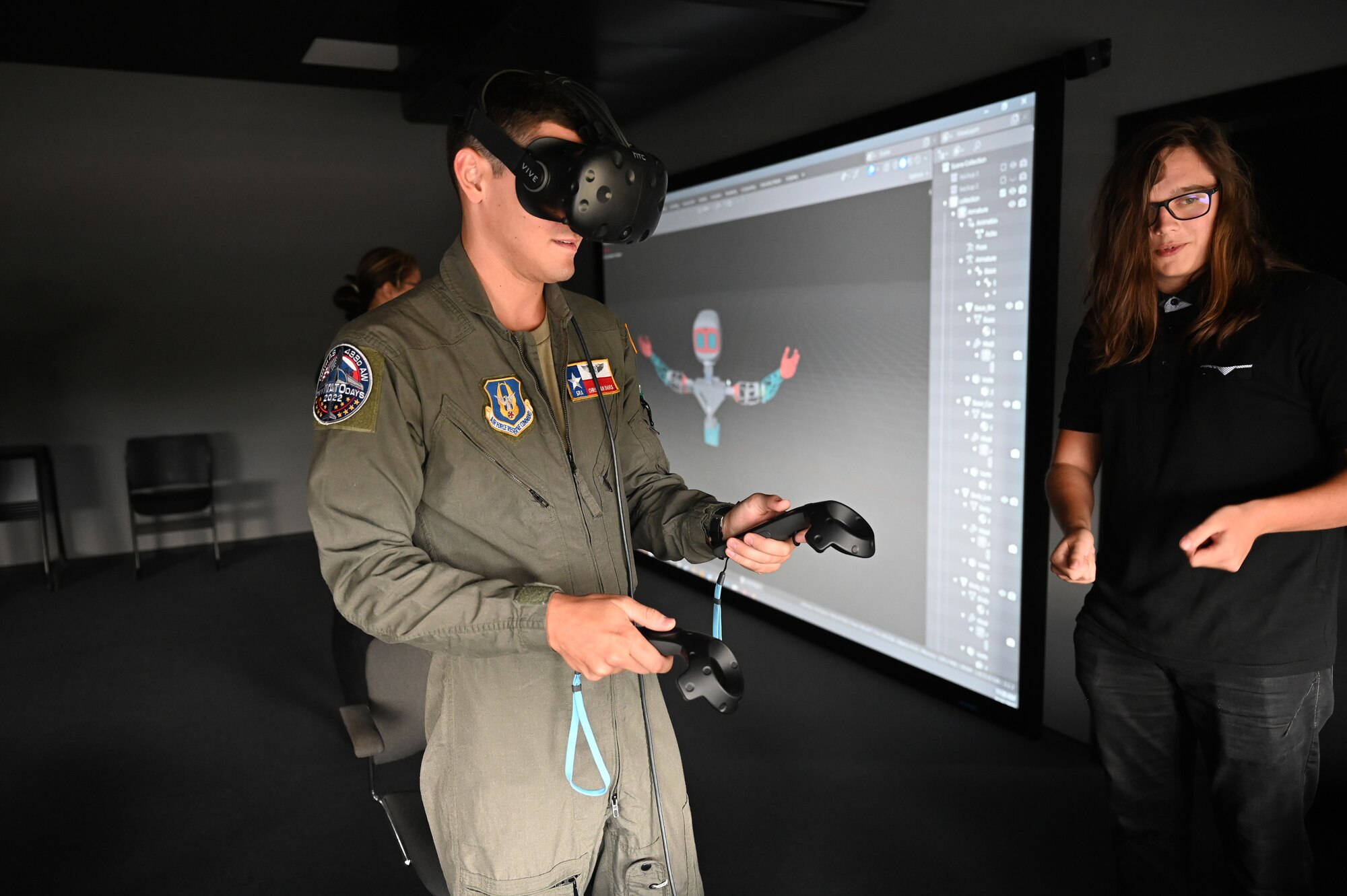 Senior Airman Christian Davis, 68th Airlift Squadron aircraft loadmaster, tests a virtual reality simulator with a student from the Secondary Vocational School Karvina, in Hranice, Czech Republic, Sept. 16, 2022. SPS is a technical school with a focus on engineering, information technology and electronics. (U.S. Air Force photo by Staff Sgt. Monet Villacorte)