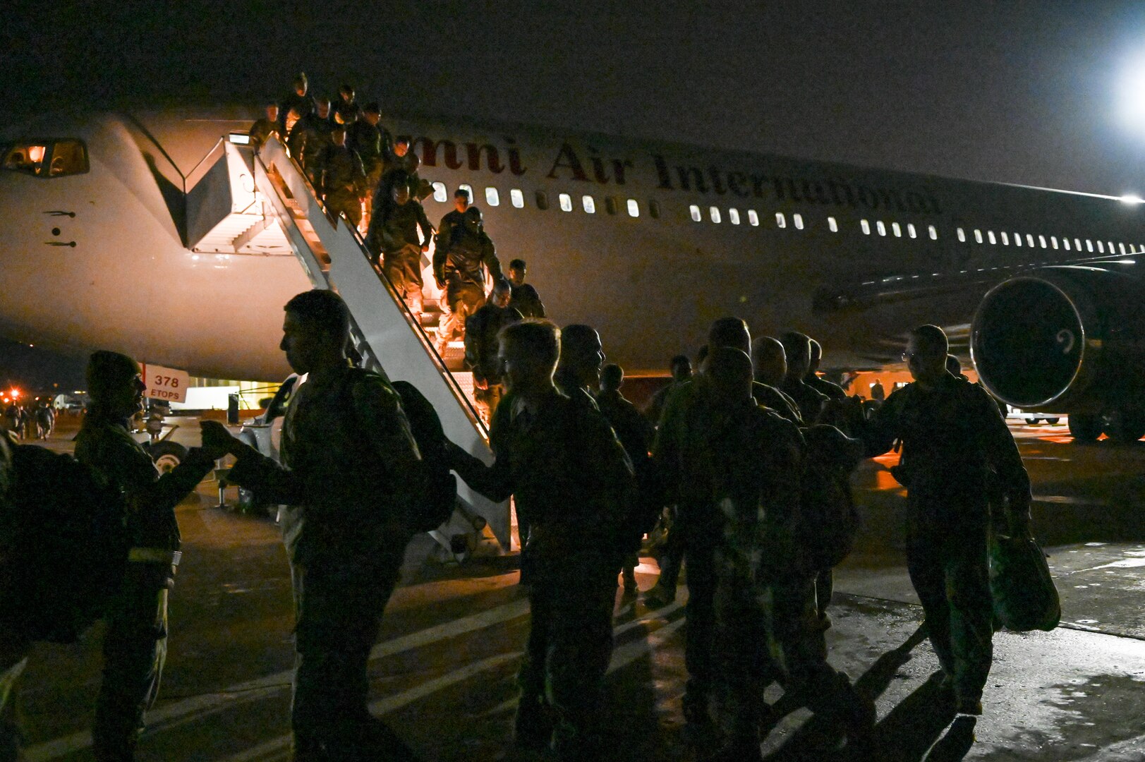 Airmen from the 23rd Expeditionary Bomb Squadron disembark a jet and are greeted by base leadership on the flightline at Minot Air Force Base, North Dakota, Sept. 24, 2022. The 23rd BS personnel were deployed to RAF Fairford, England in support of United States in Europe and Air Forces Africa command. (U.S. Air Force photo by Senior Airman Zachary Wright)