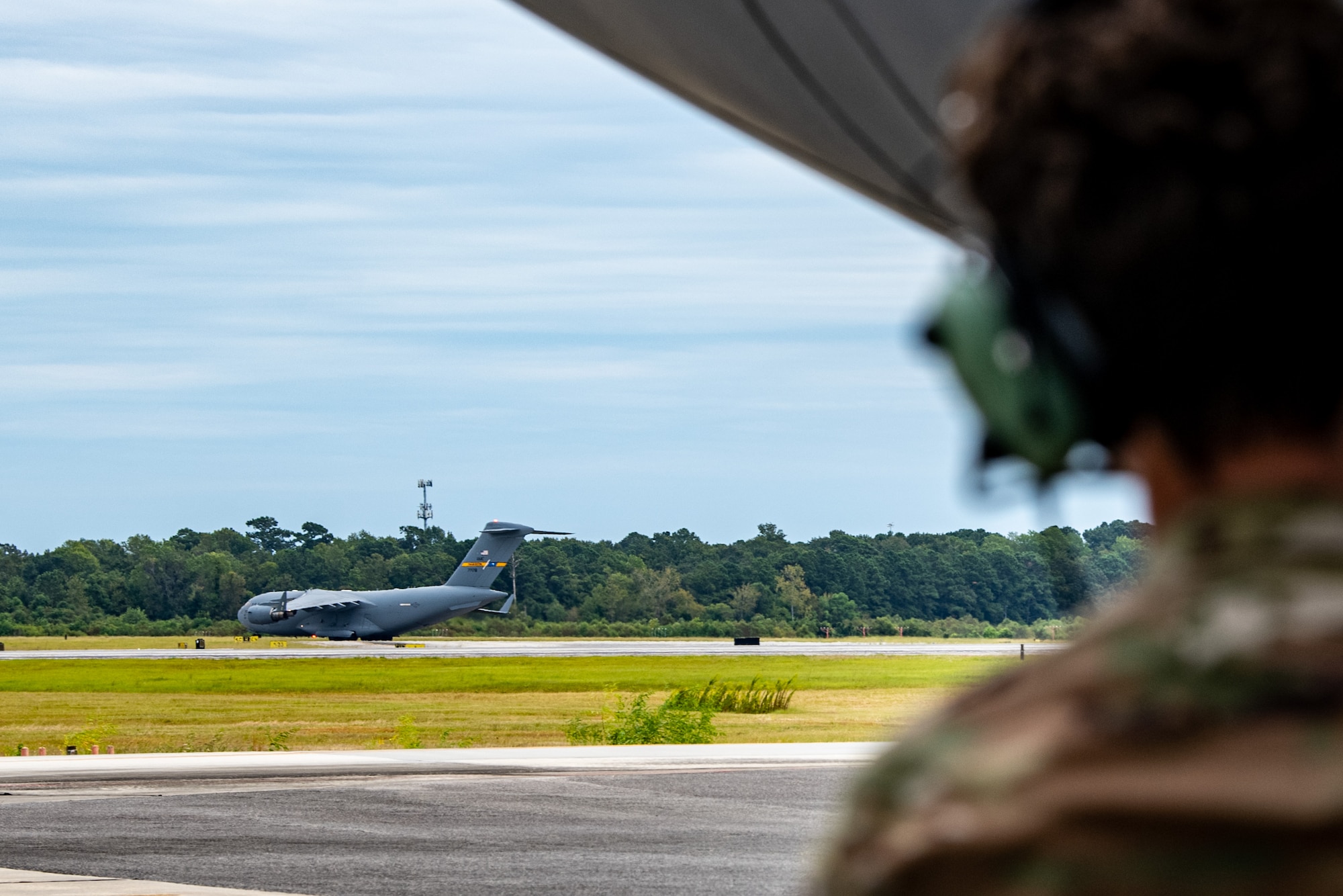 An Airman watches an aircraft take off.