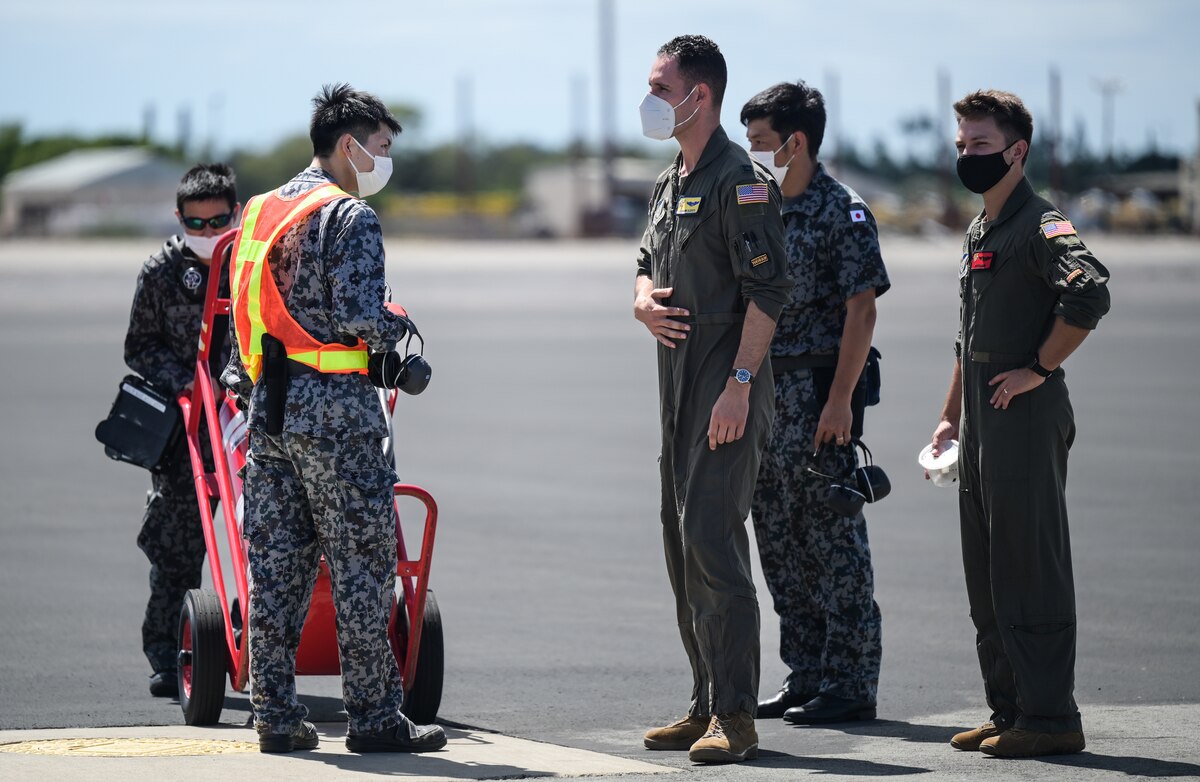 U.S. Air Force Capt. Giovanni Allevato, 535th Airlift Squadron C-17 Globemaster III pilot, and U.S. Air Force Capt. Zachary Morrow, 535th AS C-17 Globemaster III pilot, speaks to Japan Air Self-Defense Force 3rd Tactical Airlift Wing Maintenance and Supply Group Airmen during bilateral training at Joint Base Pearl Harbor-Hickam, Hawaii, Sept. 26, 2022. The USAF and JASDF will be conducting joint flying missions between the Kawasaki C-2 and the C-17, learning techniques and procedures to increase interoperability. (U.S. Air Force photo by Staff Sgt. Alan Ricker)