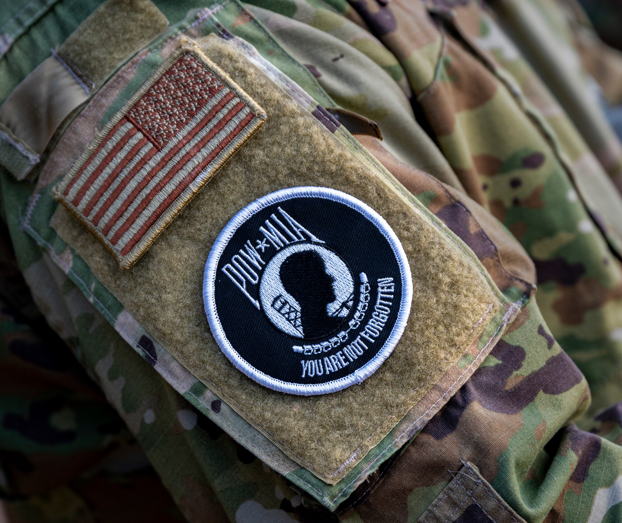 A prisoner of war and missing in action (POW/MIA) patch is affixed on the arm of Master Sgt. Andres Munoz, 51st Operations Squadron chief controller, during a remembrance ceremony at Osan Air Base, Republic of Korea, Sept. 26, 2022.