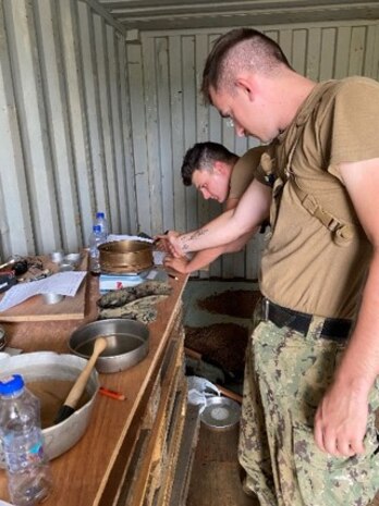 Seabees and Marine Engineers work together to perform tests on the soil for the DNK Mobile Training Campsite.