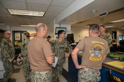 Sailors talking to each other in an office