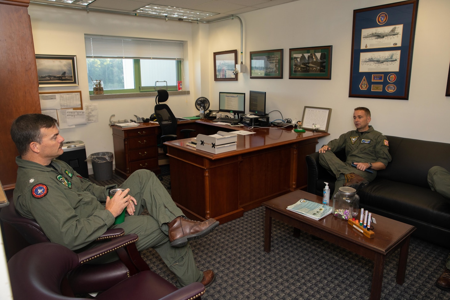 Two Naval Officers talking in an office