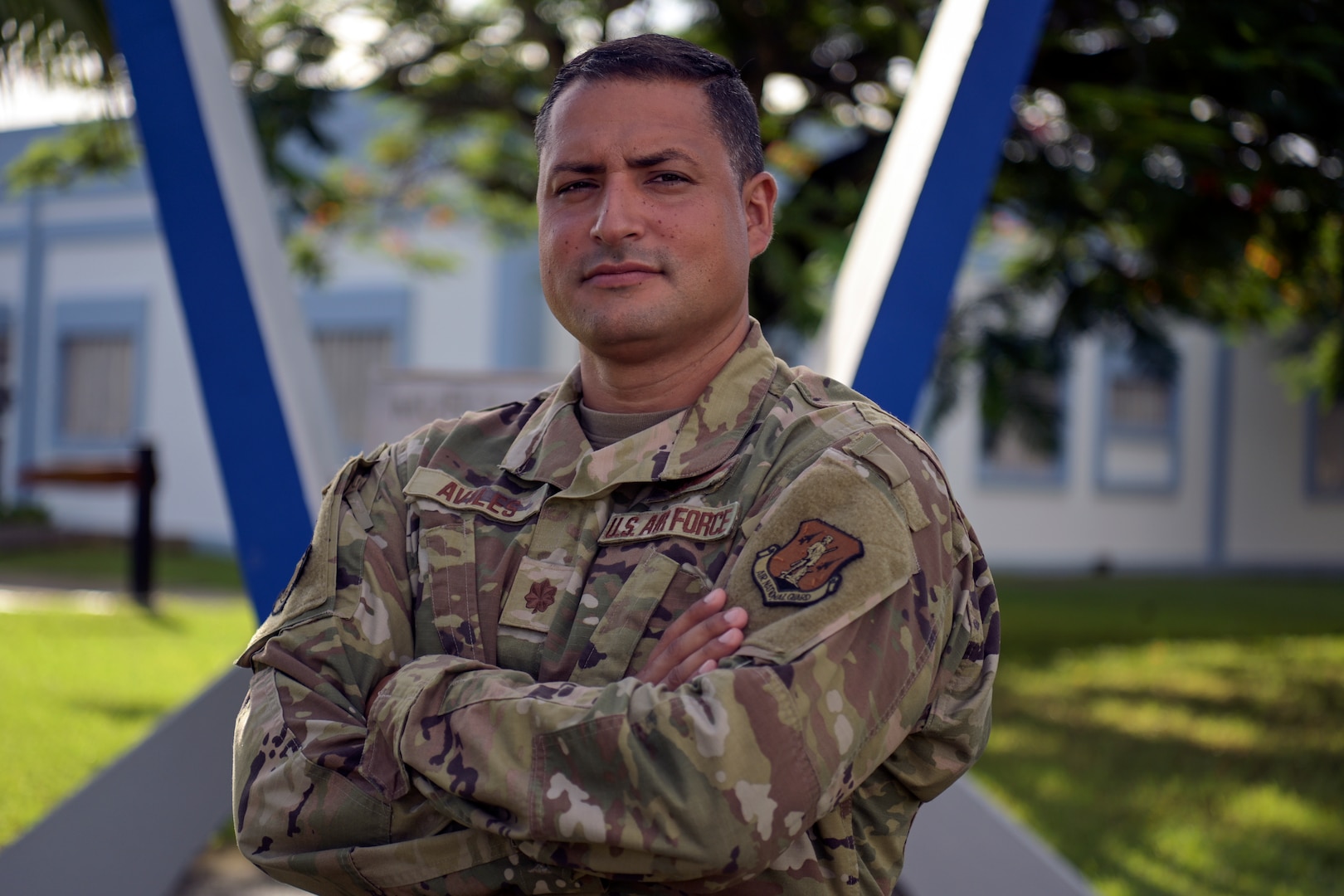 Puerto Rico Air National Guard Maj. Jesuan Aviles, the wing plans officer of the 156th Wing, stands in front of the Muñiz Memorial at Muñiz Air National Guard Base, Carolina, Puerto Rico, Sept. 16, 2022. Aviles was recognized for helping to save a cyclist's life by providing medical assistance until paramedics arrived.
