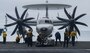 Sailors assigned to the aircraft carrier USS Nimitz (CVN 68), tow aircraft onto an elevator in the hangar bay. Nimitz is underway in the U.S. 3rd Fleet area of operations.