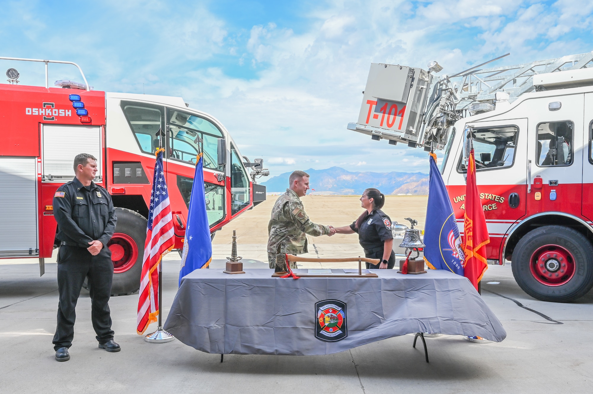 Col. Jeffrey Holland, 75th Air Base Wing commander, shakes the hand of Tiana Bykowski, 775th Civil Engineering Group training officer, after signing the proclamation Sept. 29, 2022.