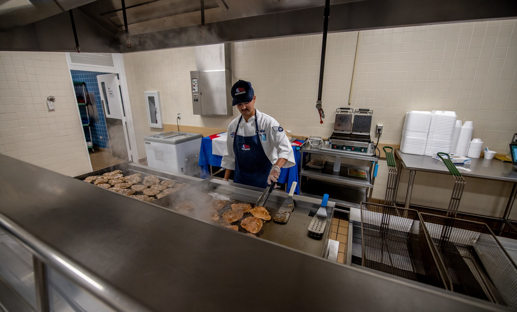 Cook cooks chicken and porkchops