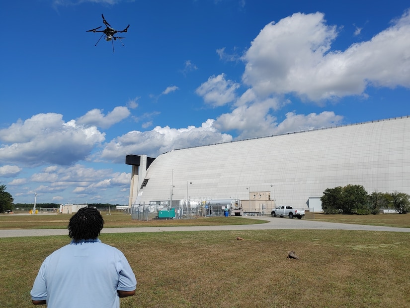 A member from the Air Force Civil Engineering Center Geo-Integration Office monitors drone during take-off.