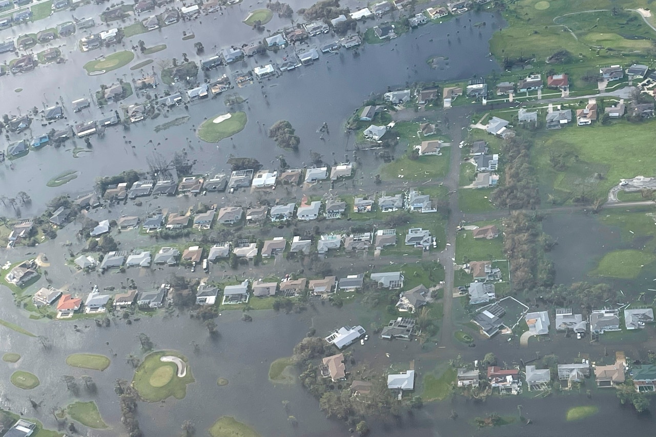 A neighborhood flooded after a hurricane is seen from overhead.