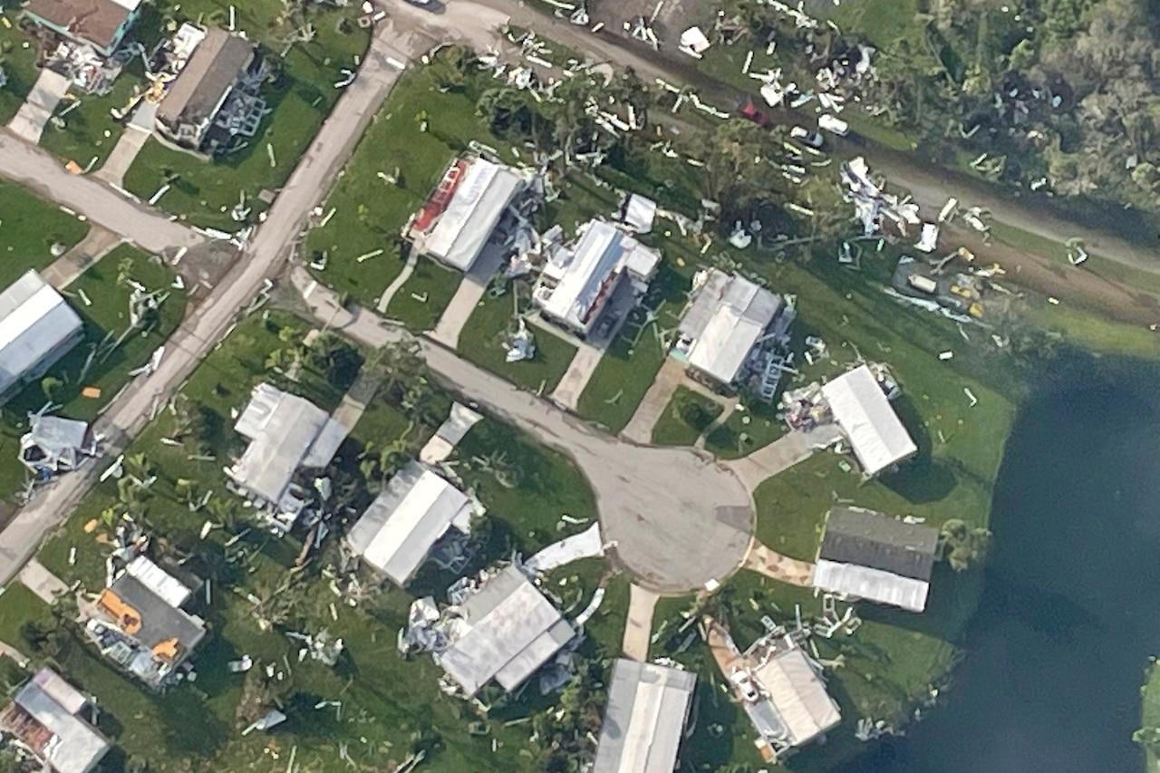 Homes on a cul-de-sac damaged by a hurricane are seen from overhead.