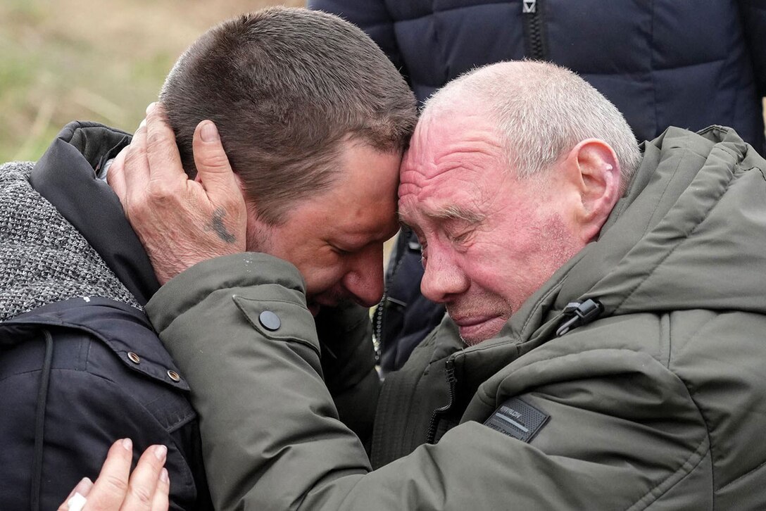 Relatives cry at the mass grave of civilians killed during Russian occupation in Bucha, on the outskirts of Kyiv, Ukraine.