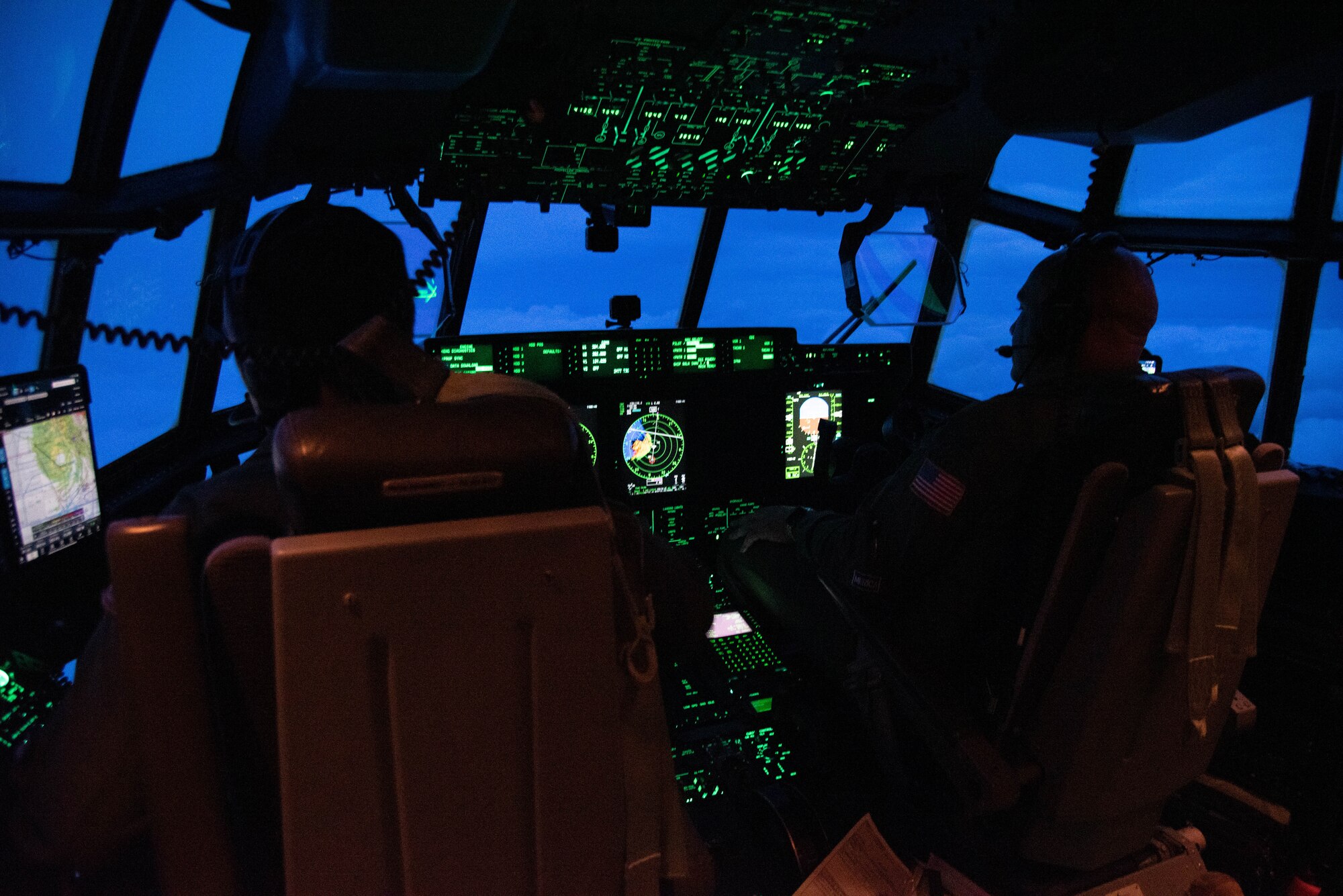Pilots on flight deck of WC-130J flying into Hurricane Ian.