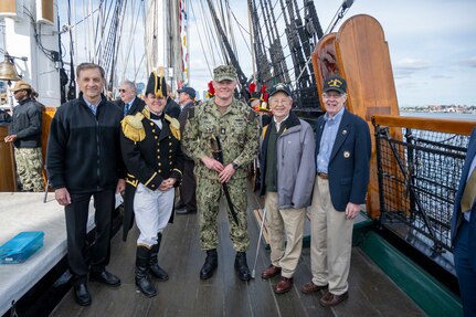 BOSTON (Sept. 30, 2022) Chief Gas Turbine Systems Technician (Mechanical) Adam Yenny poses with current and former Navy leadership after receiving the 2021 USS Constitution George Sirian Meritorious Leadership Award while underway aboard USS Constitution. The USS Constitution George Sirian Meritorious Leadership Award recognizes a chief petty officer who embodies former USS Constitution crew member George Sirian through their technical expertise, dedication, and leadership. USS Constitution, is the world’s oldest commissioned warship afloat, and played a crucial role in the Barbary Wars and the War of 1812, actively defending sea lanes from 1797 to 1855. During normal operations, the active-duty Sailors stationed aboard USS Constitution provide free tours and offer public visitation to more than 600,000 people a year as they support the ship’s mission of promoting the Navy’s history and maritime heritage and raising awareness of the importance of a sustained naval presence. USS Constitution was undefeated in battle and destroyed or captured 33 opponents. The ship earned the nickname of Old Ironsides during the war of 1812 when British cannonballs were seen bouncing off the ship’s wooden hull. (U.S. Navy Photo Illustration by Mass Communication Specialist 1st Class Grant G. Grady/Released)