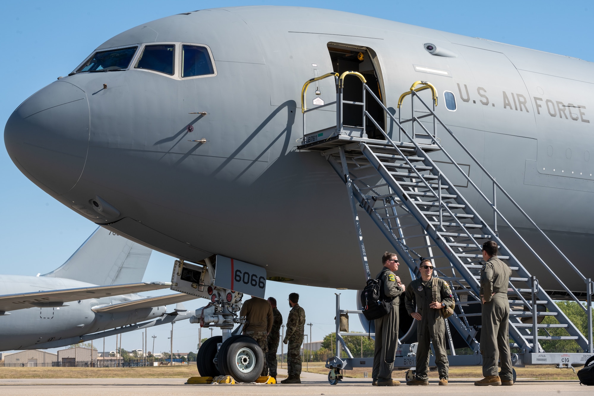 Pilots and maintenance crews from the 916th Air Refueling Wing await transport after landing on Sep. 29, 2022, at McConnell Air Force Base, Kansas. 41 Airmen accompanied the nine KC-46As sent to escape the path of hurricane Ian. (U.S. Air Force photo by Staff Sgt. Nathan Eckert)