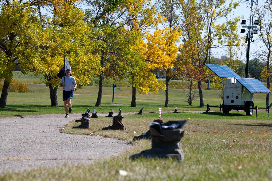 Team Minot Airmen participate in a POW/MIA commemoration run, Minot Air Force Base, North Dakota, Sept. 29, 2022.