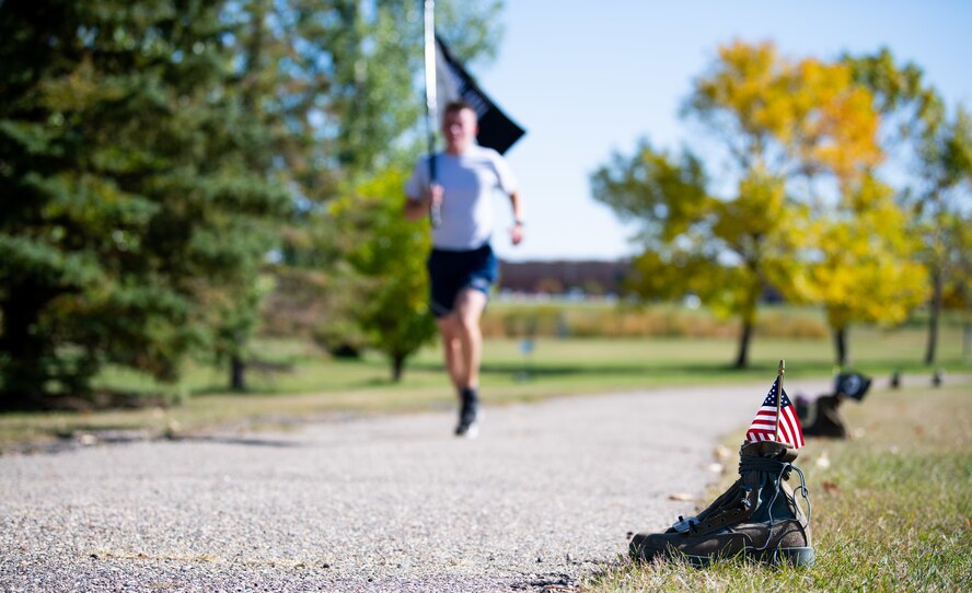 Team Minot Airmen participate in a POW/MIA commemoration run, Minot Air Force Base, North Dakota, Sept. 29, 2022.