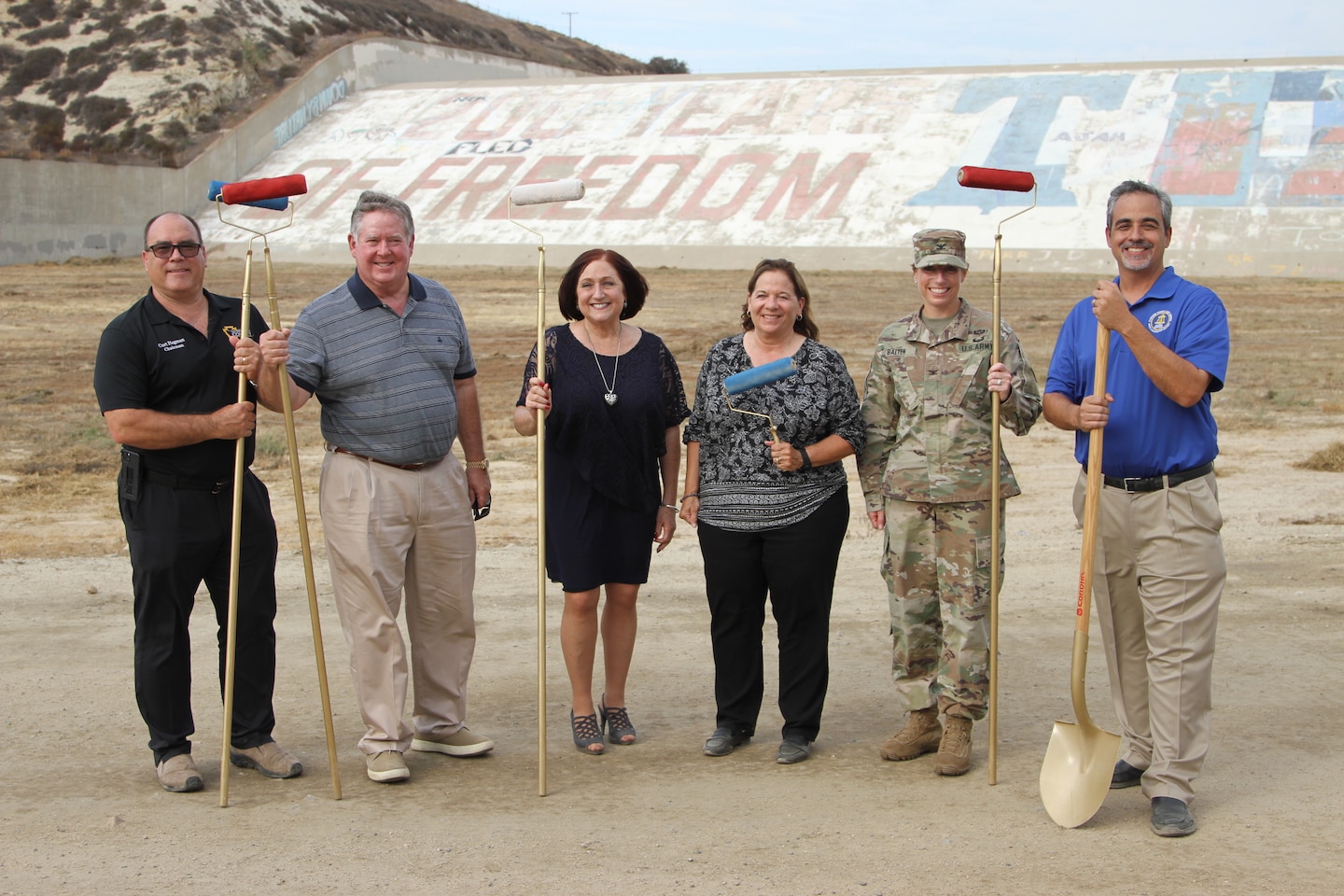 Col. Julie Balten, U.S. Army Corps of Engineers Los Angeles District commander, second from left, stands with a group of officials and partners for photos after the Sept. 8 Prado Dam mural groundbreaking ceremony in Corona, California. The event included officials from Riverside, Orange and San Bernardino counties, as well as other local city mayors and leaders.

From left to right: San Bernardino County Fourth District Supervisor Curt Hagman; U.S. Rep. Ken Calvert (CA-42); Riverside County Second District Supervisor (and former mayor of Corona) Karen Spiegel; Terri Smith Ferguson, a member of the Corona High School Class of 1976 and the one who came up with the idea of painting a bicentennial theme on the Prado Dam spillway; Col. Julie Balten, U.S. Army Corps of Engineers Los Angeles District commander; and Jason Uhley, Riverside County Flood Control and Water Conservation District general manager and chief engineer.