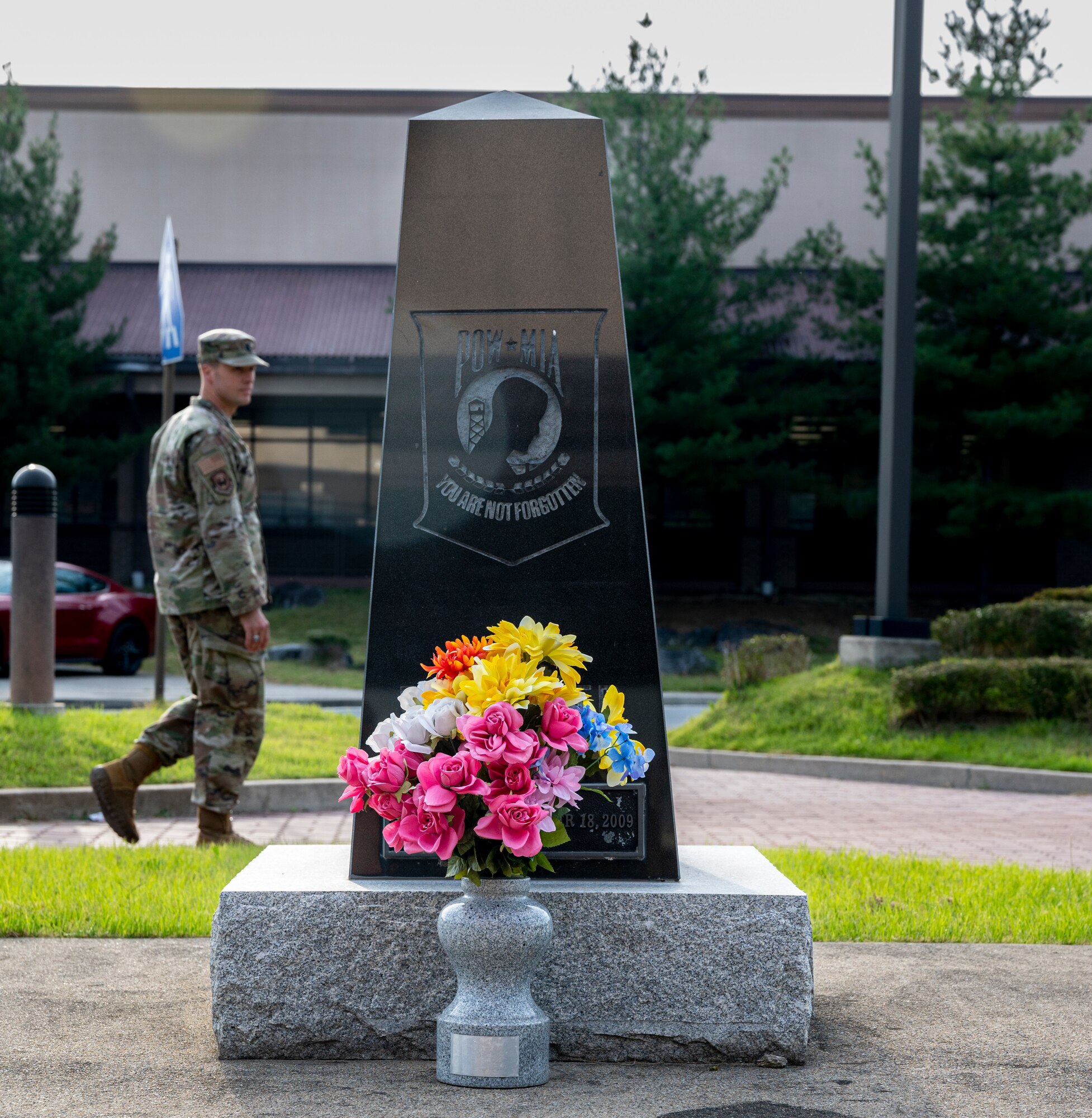 An Airman assigned to the 51st Fighter Wing walks past a prisoner of war and missing in action (POW/MIA) memorial at Osan Air Base, Republic of Korea, Sept. 26, 2022.