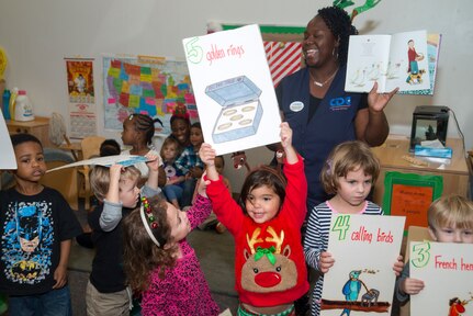 Students from the Child Development Center at MacDill Air Force Base, Fla., sing Christmas carols at the CDC  No.1, Dec. 21, 2017. Effective Oct. 1, 2022, DAF Child Development Program direct-care employees will receive a 100% childcare fee waiver for their first child enrolled in installation Child Development Programs. (U.S. Air Force photo by Airman 1st Class Scott Warner)