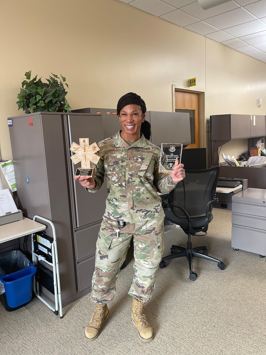 Pennington in uniform holding awards