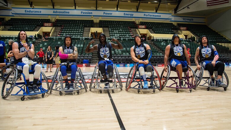 Group photo of wheelchair athletes on an indoor court
