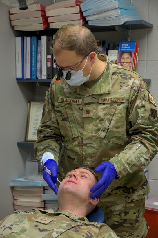 U.S. Air Force Maj. Andrew Blackwell, 104th Medical Group dental officer, conducts an exam on U.S. Air Force Master Sgt. Christopher Catyb, Mission Support Group training manager, during the annual Periodic Health Assessments at Barnes Air National Guard Base, Mass., March 4, 2023. Dental exams ensure Airmen do not have dental or periodontal issues, such as cavities, which may put them at risk of becoming non-deployable or may require further attention. (U.S. Air National Guard Photo by Staff Sgt. Sara Kolinski)