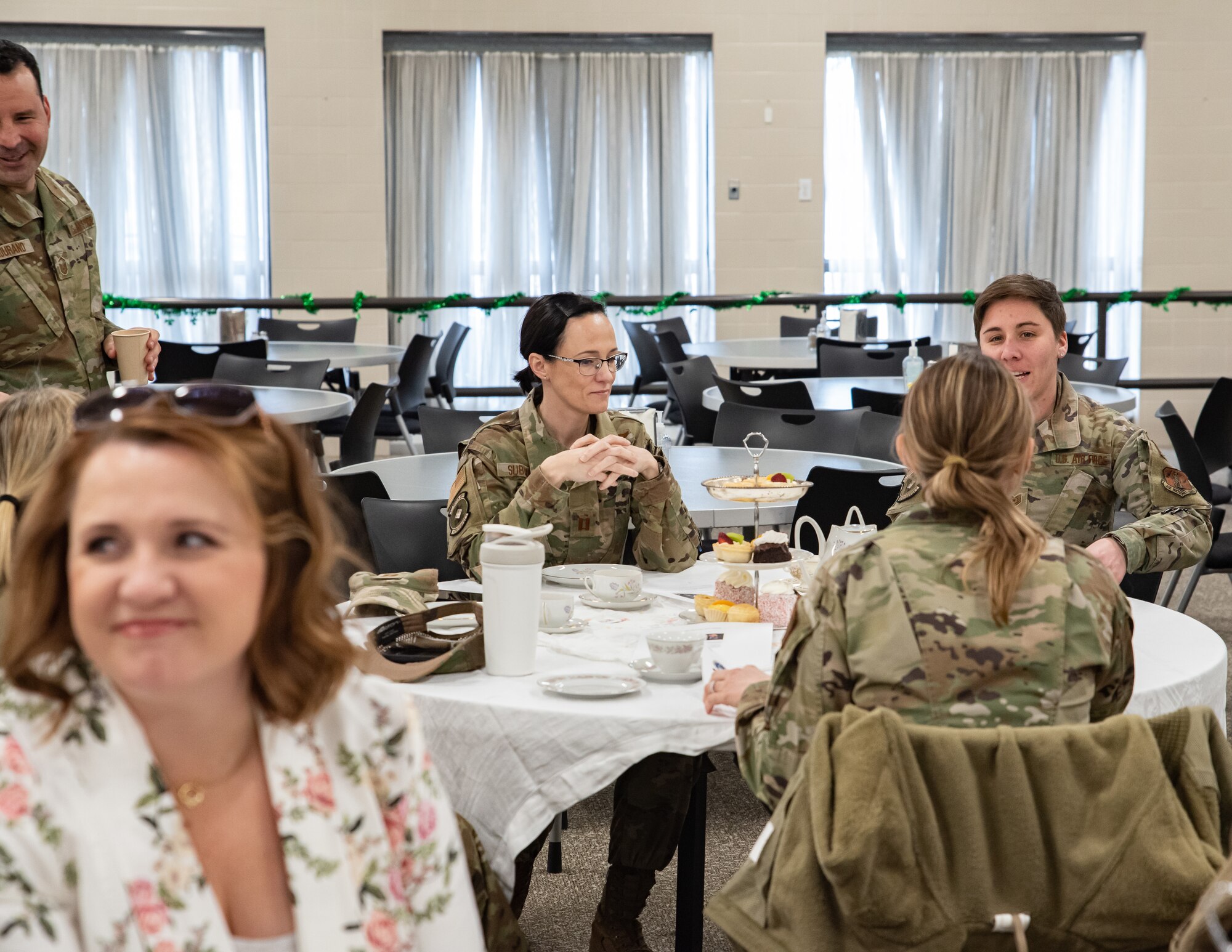 A group of women enjoy tea and snacks at a table