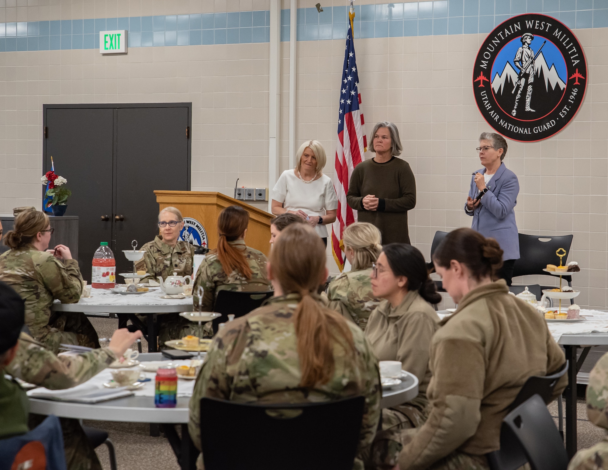 Three retired military women, speak to a group of currently serving military women.