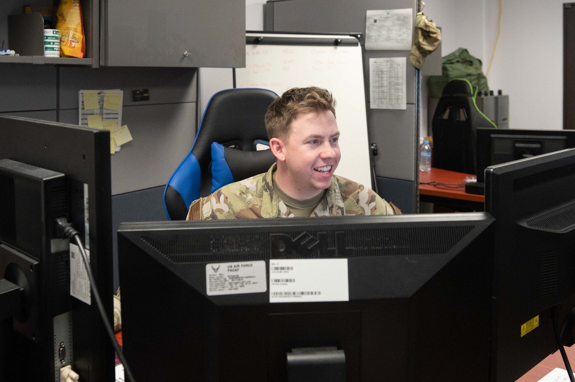 Airman sits at his work station