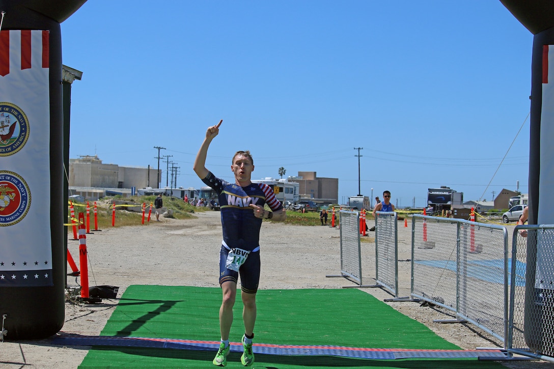 Navy Cmdr. Kyle Hooker of Washington, D.C. wins the men's division of the 2023 Armed Forces Triathlon Championship hosted by Naval Base Ventura County, California on April 1.  The Armed Forces Championship features teams from the Army, Marine Corps, Navy (with Coast Guard runners), and Air Force (with Space Force Runners).  Department of Defense Photo by Mr. Steven Dinote - Released.