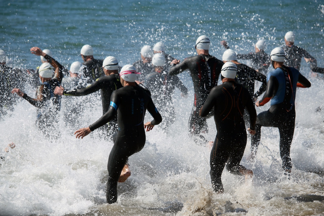 Swimmers take to the water during the 2023 Armed Forces Triathlon Championship hosted by Naval Base Ventura County, California on April 1.  The Armed Forces Championship features teams from the Army, Marine Corps, Navy (with Coast Guard runners), and Air Force (with Space Force Runners).  Department of Defense Photo by Mr. Steven Dinote - Released.
