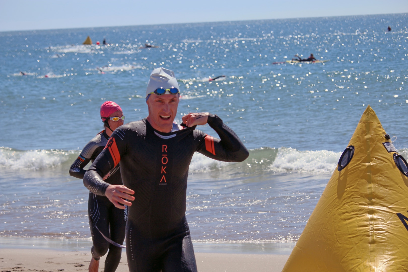Navy Lt. Cmdr Kyle Hooker leads the pack out of the water during the 2023 Armed Forces Triathlon Championship hosted by Naval Base Ventura County, California on April 1.  The Armed Forces Championship features teams from the Army, Marine Corps, Navy (with Coast Guard runners), and Air Force (with Space Force Runners).  Department of Defense Photo by Mr. Steven Dinote - Released.
