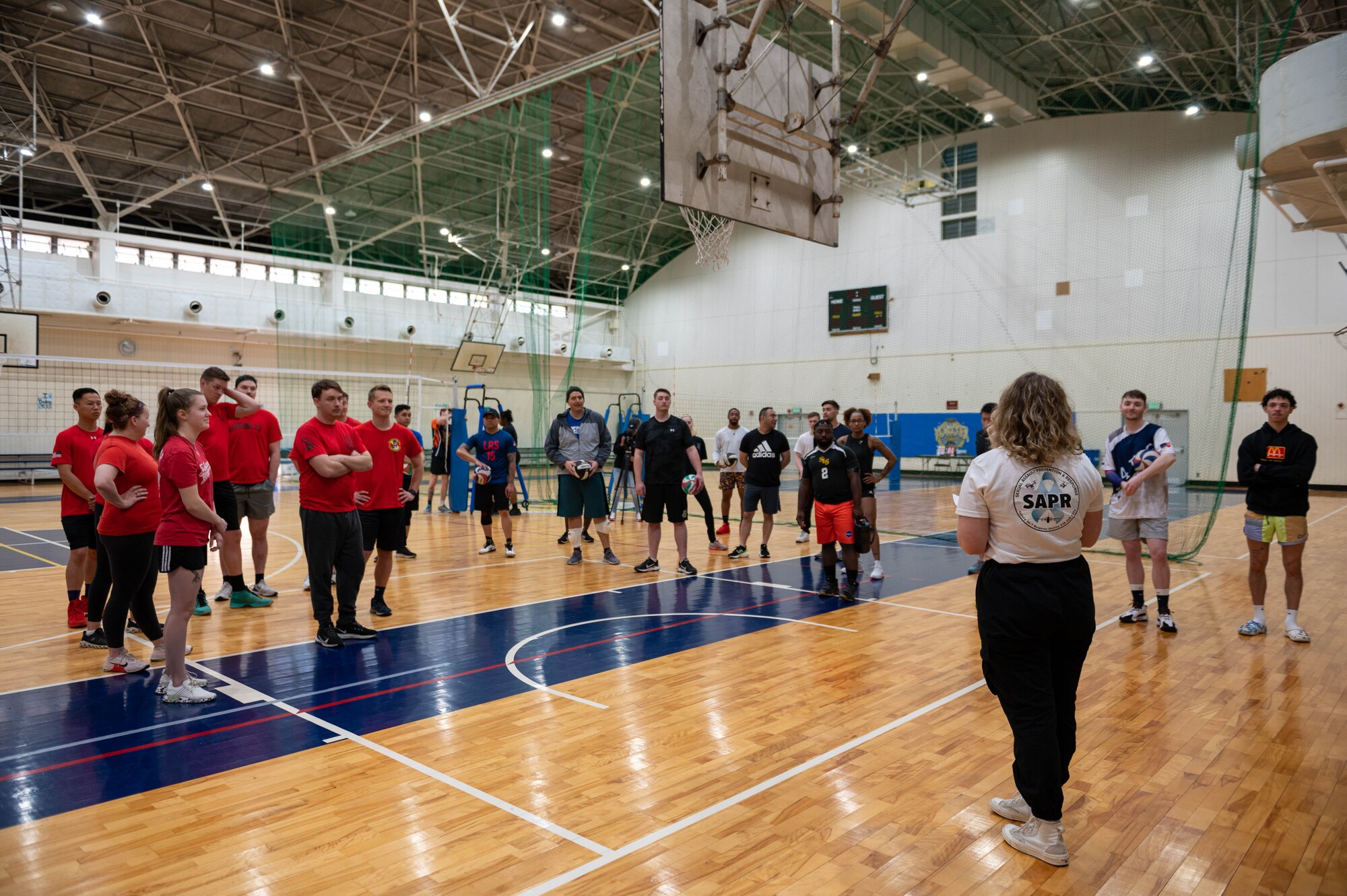 Airmen congregate before the start of a volleyball tournament.