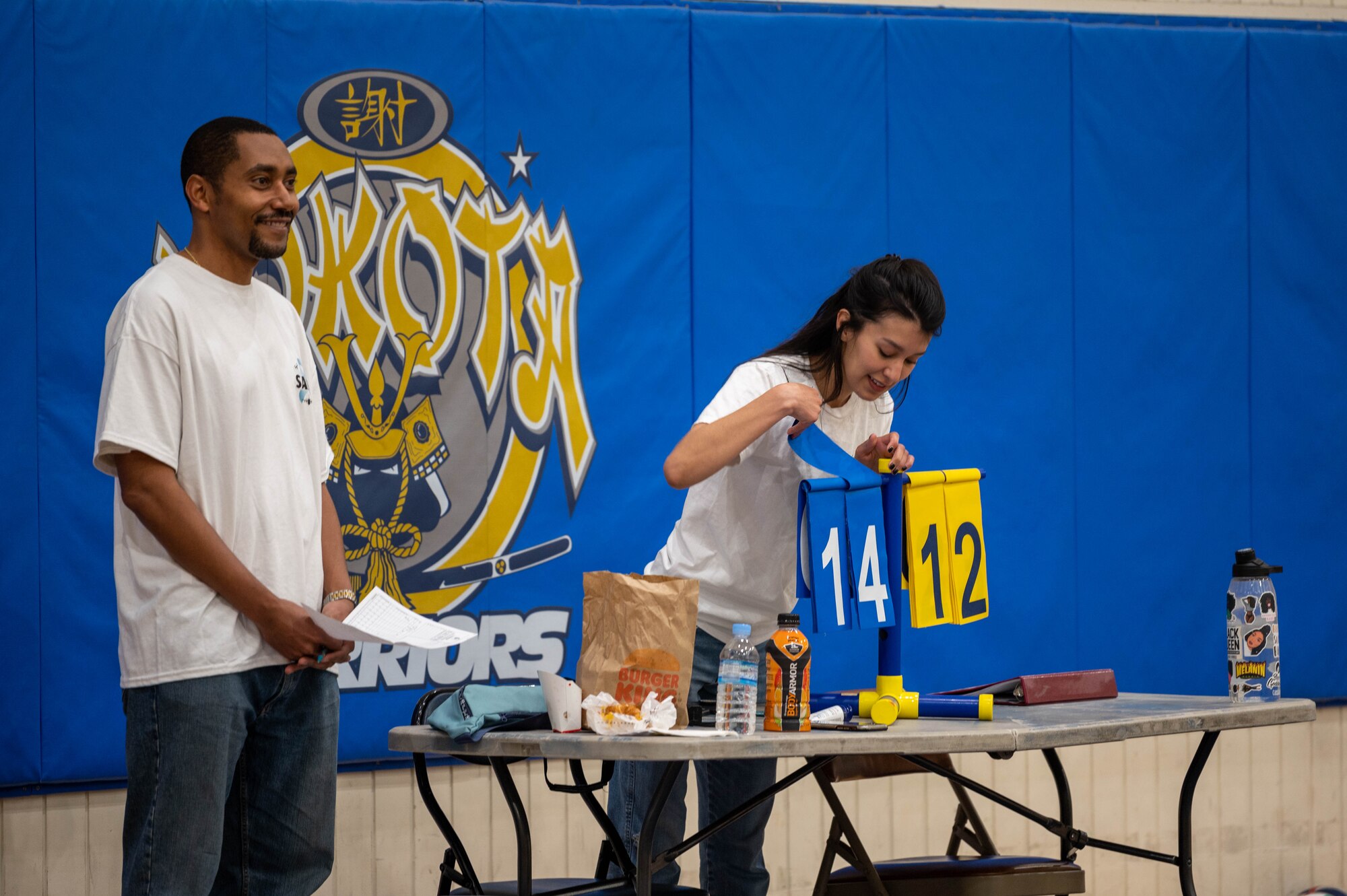 Two people keep score during a volleyball tournament.