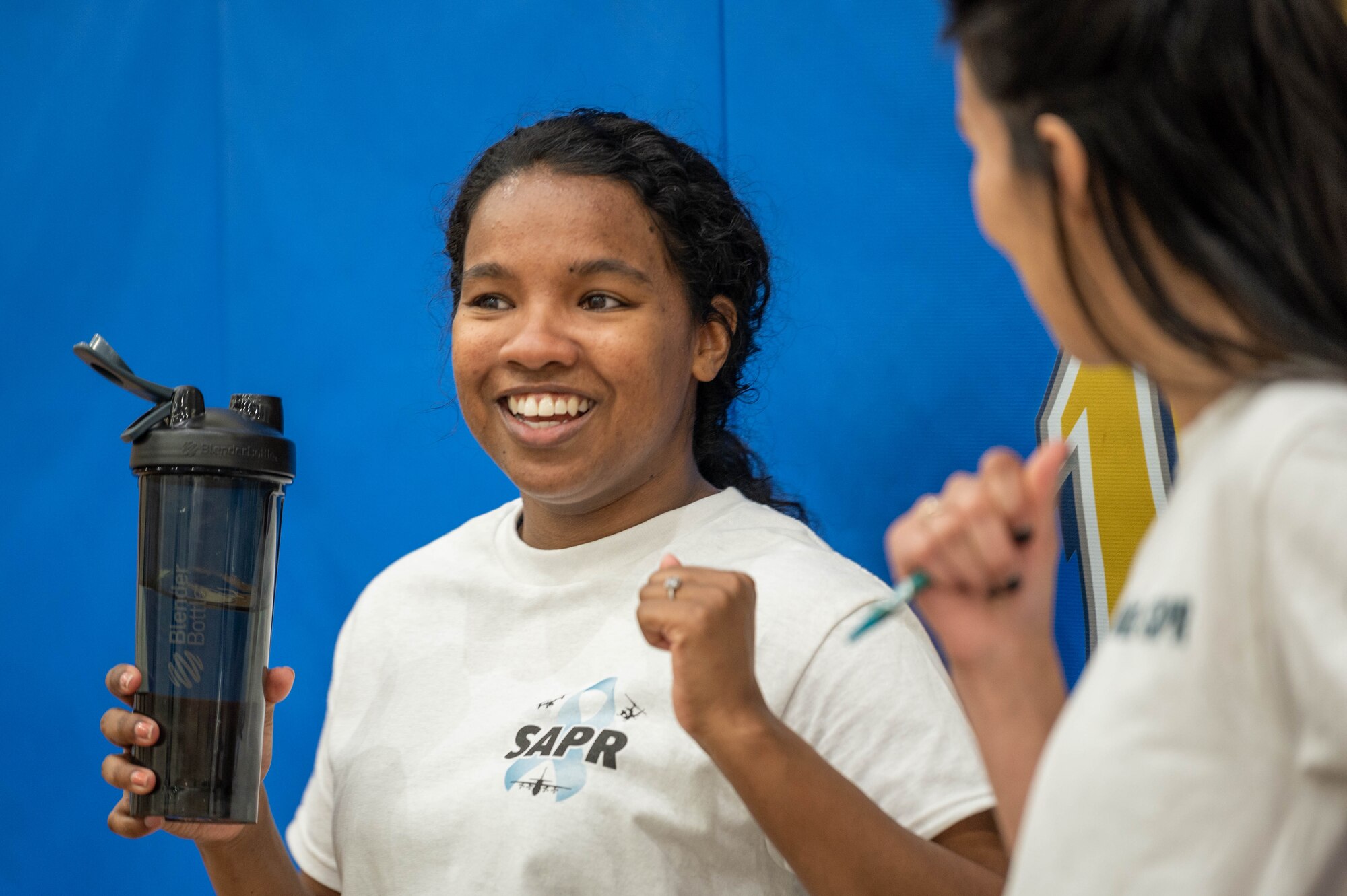 A woman takes a break during a volleyball tournament.