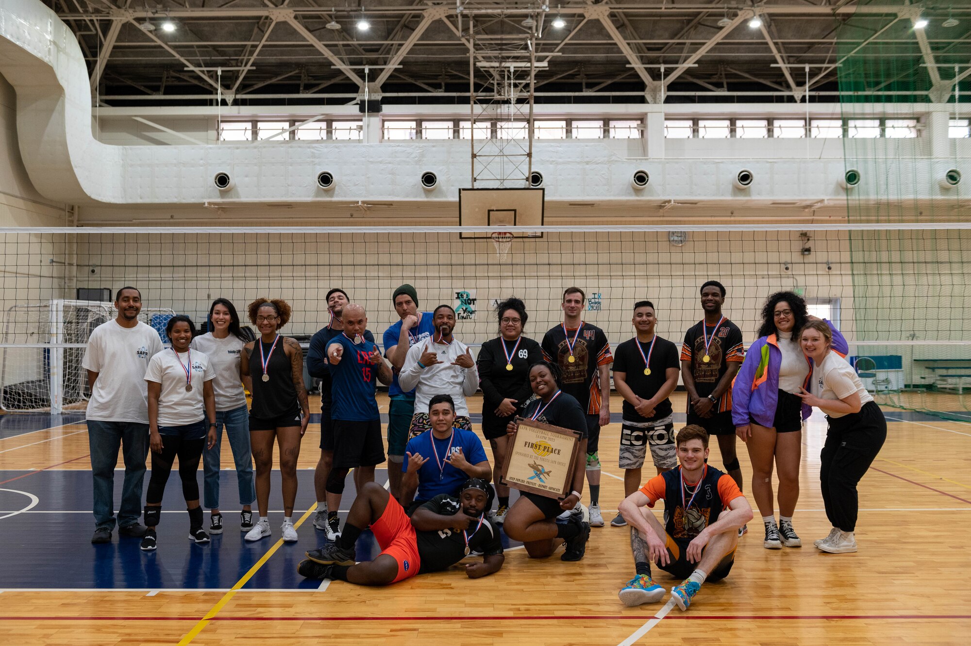 The winners of a volleyball tournament hosted by the 374th Airlift Wing Sexual Assault Prevention and Response office pose for a photo.