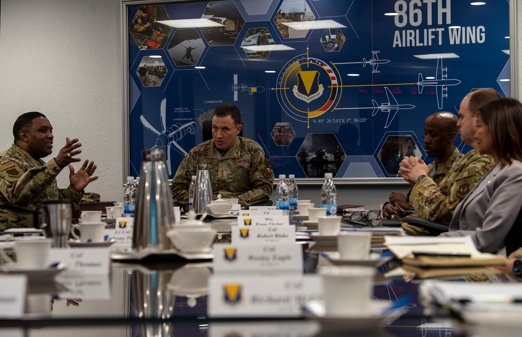 Airmen sit at a table for a discussion