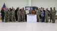 Maj. Gen. Michel M. Russell Sr., commanding general of the 1st Theater Sustainment Command, and Command Sgt. Maj. Albert E. Richardson Jr., command sergeant major of the 1st TSC, joins Soldiers attending the LeadHERship forum for a group photo at Camp Arifjan, Kuwait, March 30, 2023.