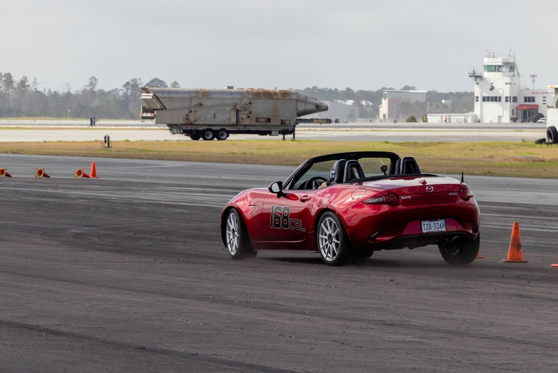 A participant in the Sports Car Club of America (SCCA) North Carolina Region Autocross event maneuvers through the obstacle course on Marine Corps Air Station Cherry Point, North Carolina, March 25, 2023. The SCCA teams up with the MCAS Cherry Point Single Marine Program semiannually to provide a timed obstacle course to improve driving skills, car control, and overall driving safety for U.S. Marines, Sailors and civilians in the community. (U.S. Marine Corps photo by Lance Cpl. Lauralle Walker)