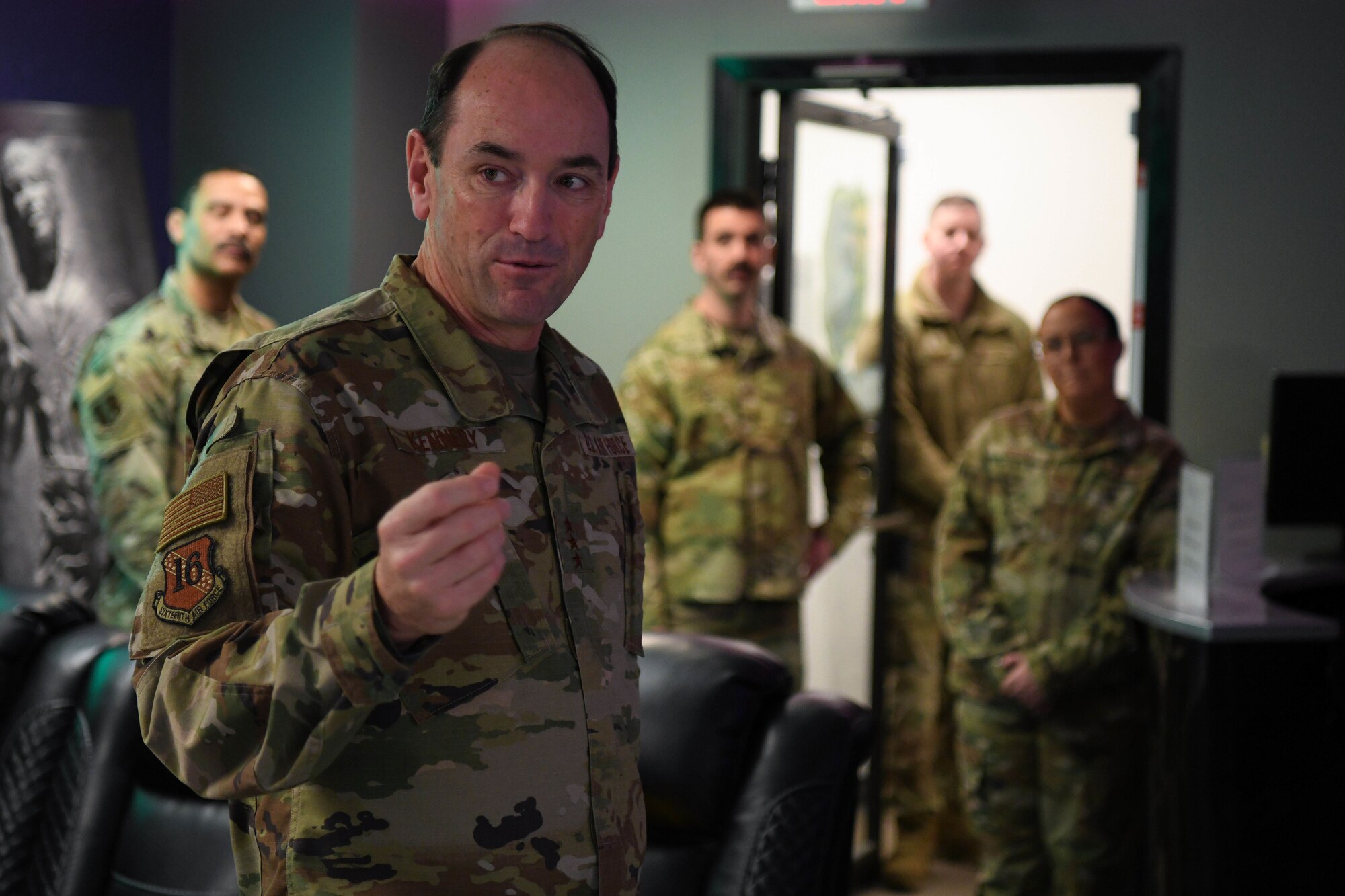 Man in green uniform speaks